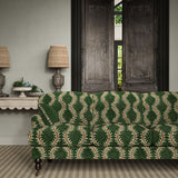 Sofa upholstered in a printed velvet fabric in green and orange featuring a stylized fern pattern.