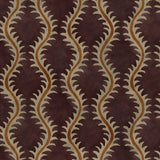 A printed velvet fabric sample in purple and orange featuring a stylized fern pattern.