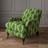 Armchair upholstered in a printed velvet fabric in green and blue
featuring a stylized fern pattern.