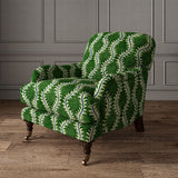 Armchair upholstered in a printed velvet fabric in green and blue featuring a stylized fern pattern.