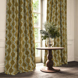 Curtains in a printed velvet fabric in brown and blue featuring a stylized fern pattern.