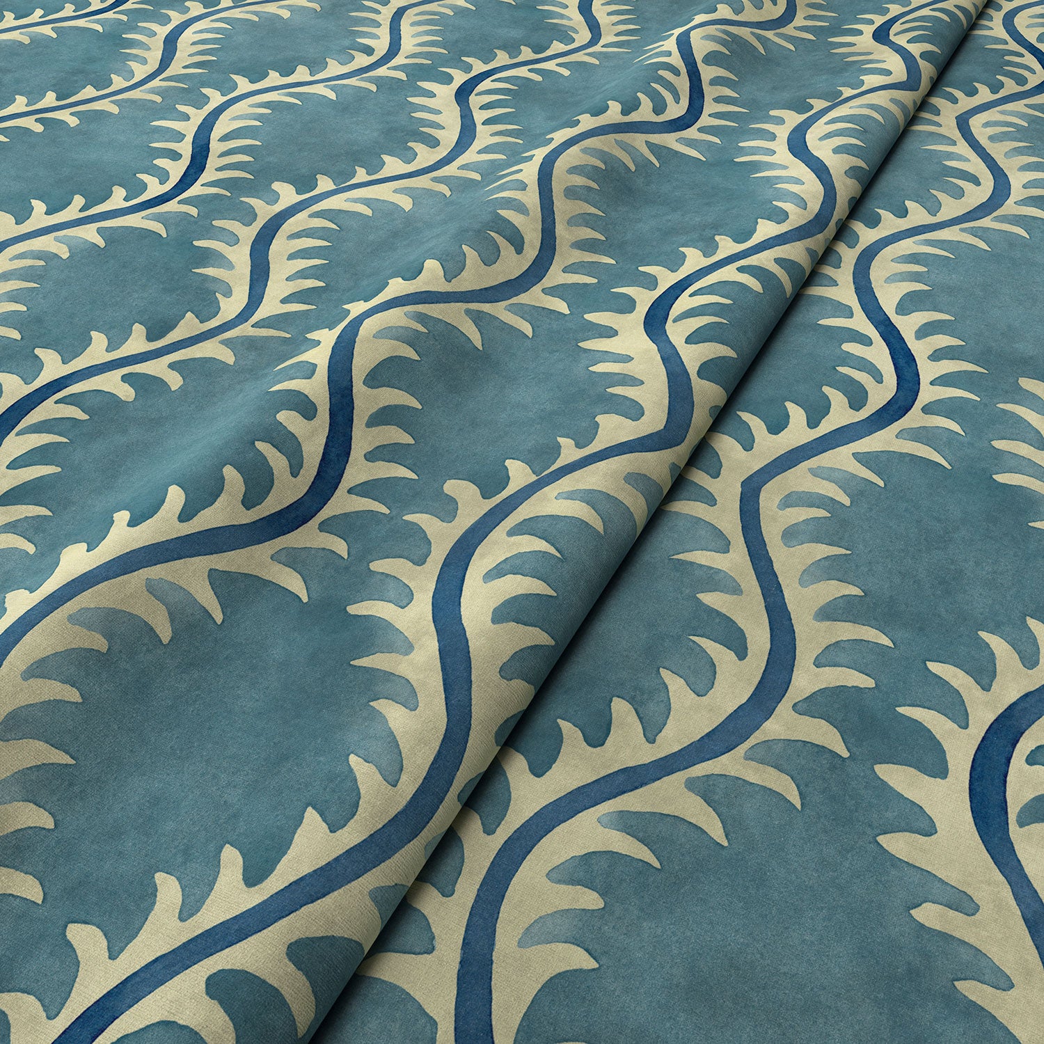 A printed velvet fabric sample in blue and off white featuring a stylized fern pattern.