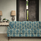 Sofa upholstered in a printed velvet fabric in blue and off white featuring a stylized fern pattern.