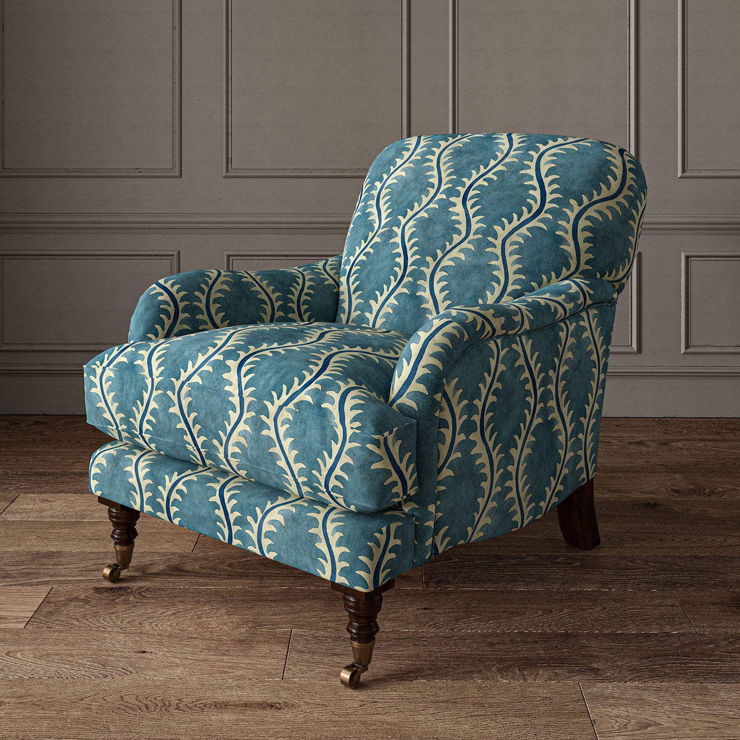 Armchair upholstered in a printed velvet fabric in blue and off white featuring a stylized fern pattern.