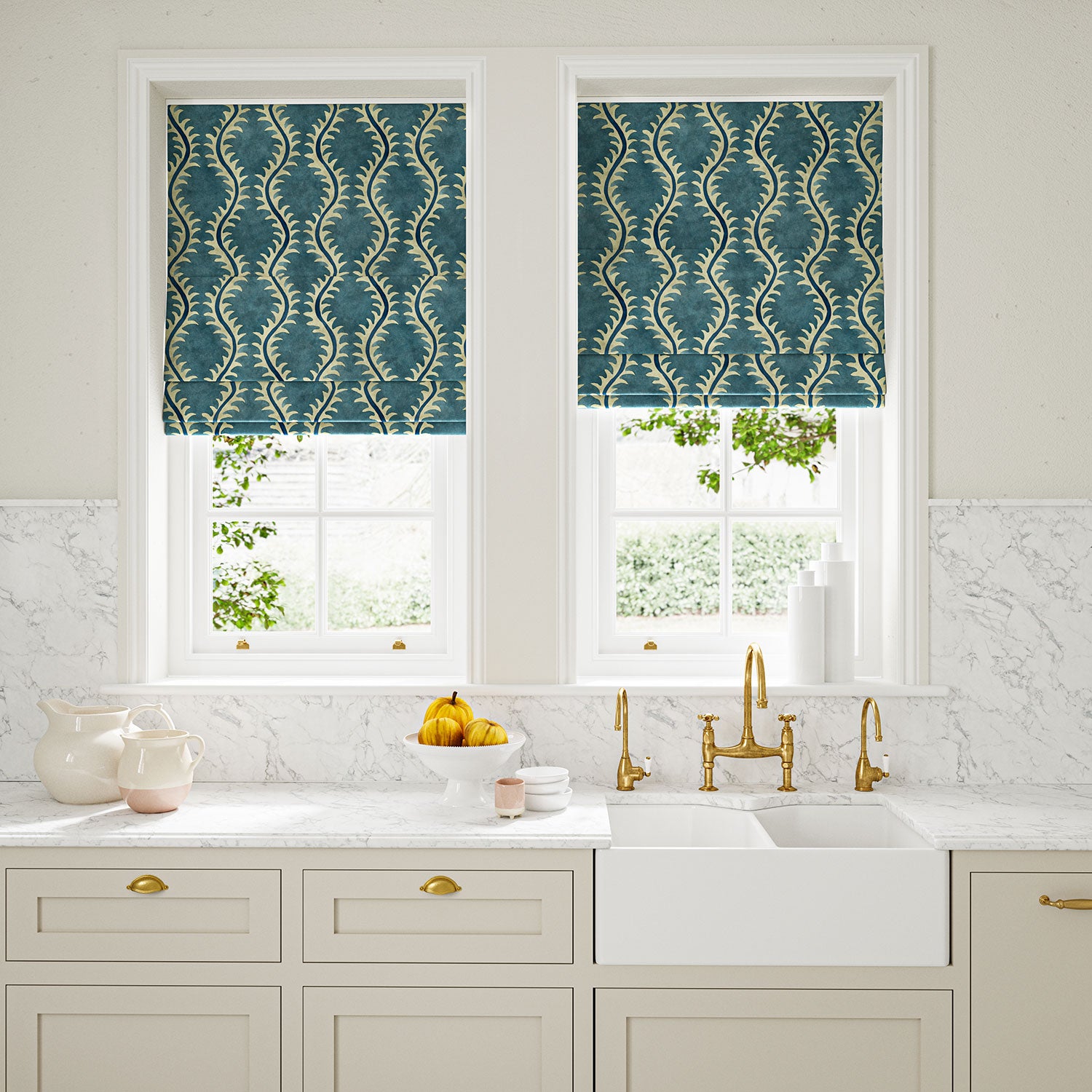 Blinds in a printed velvet fabric in blue and off white featuring a stylized fern pattern.