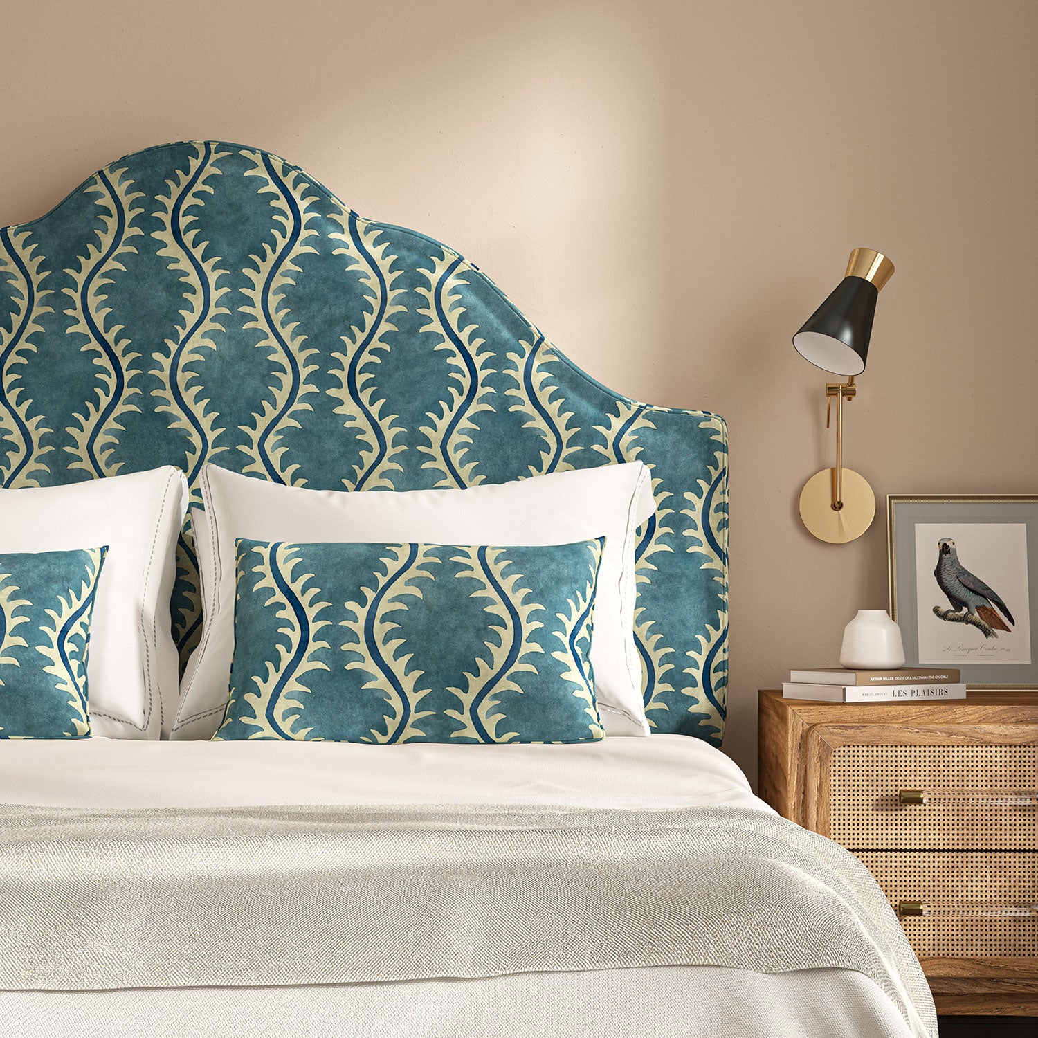 Headboard upholstered in a printed velvet fabric in blue and off white featuring a stylized fern pattern.