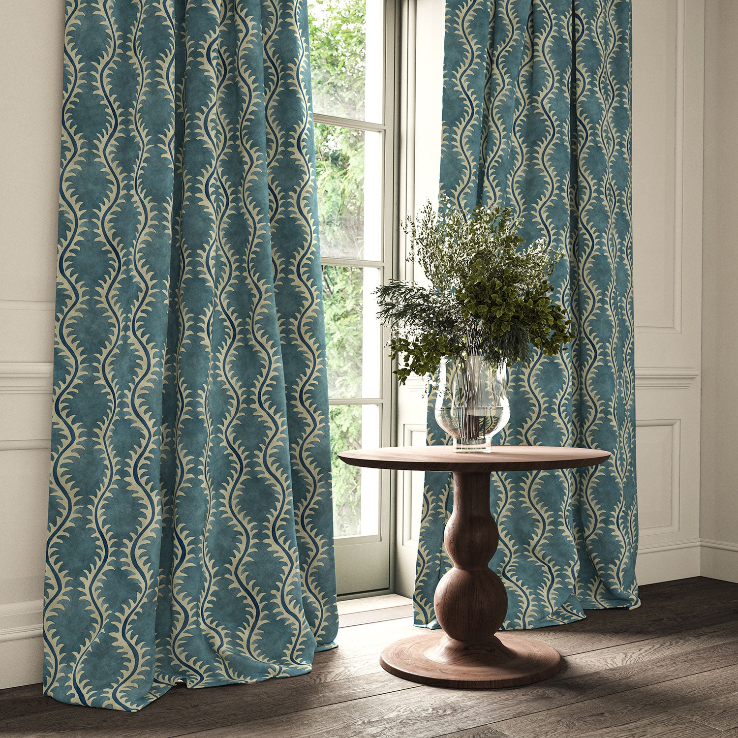 Curtains in a printed velvet fabric in blue and off white featuring a stylized fern pattern.