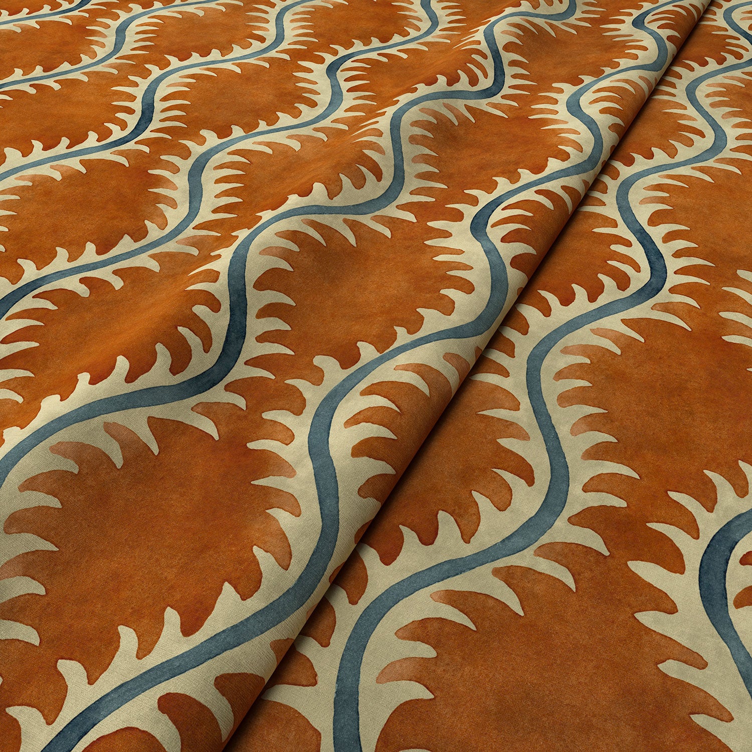 A printed velvet fabric sample in orange and blue featuring a stylized fern pattern.