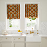 Blinds in a printed velvet fabric in orange and blue featuring a stylized fern pattern.