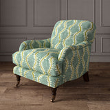 Armchair upholstered in a printed velvet fabric in blue and green featuring a stylized fern pattern.