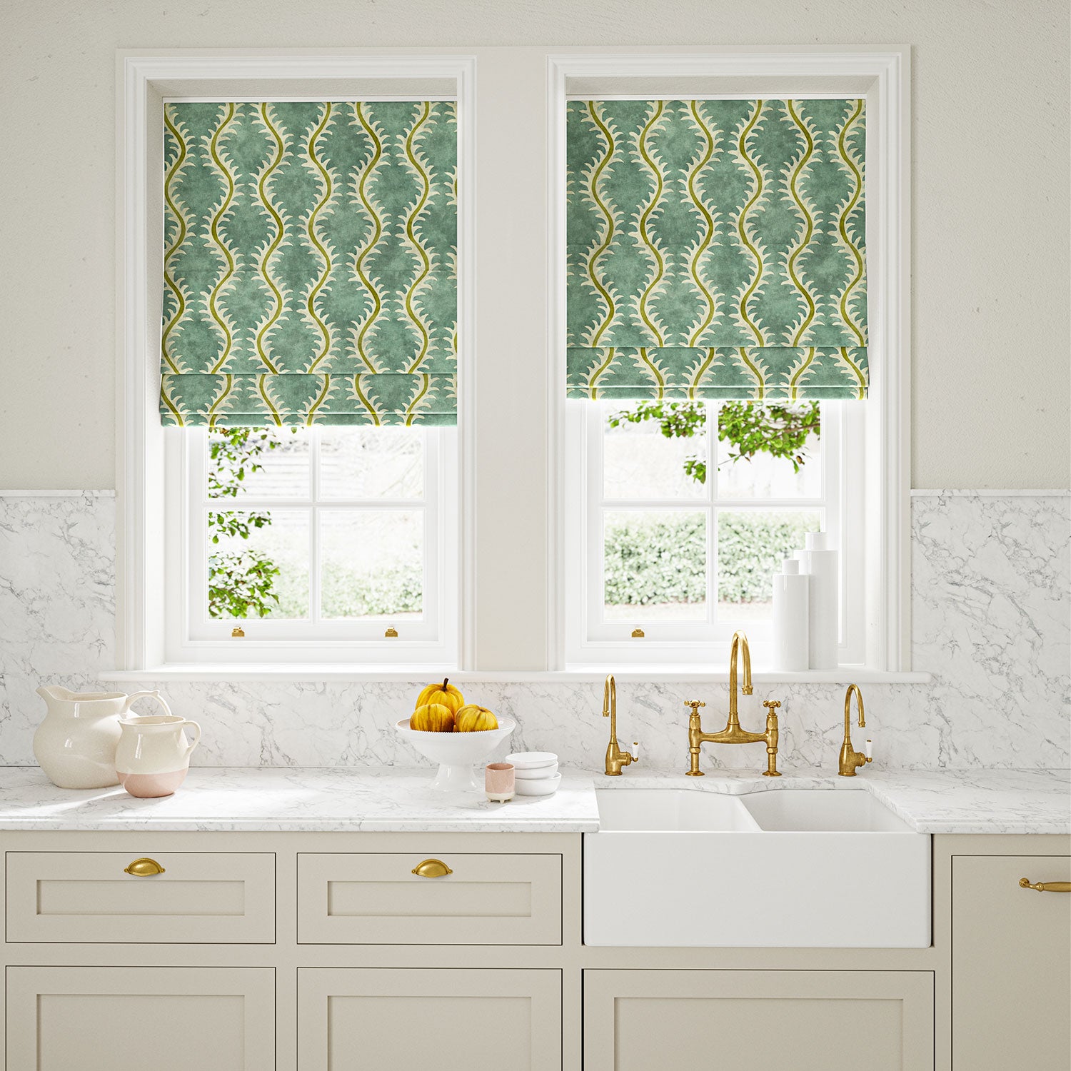 Blinds in a printed velvet fabric in blue and green featuring a stylized fern pattern.