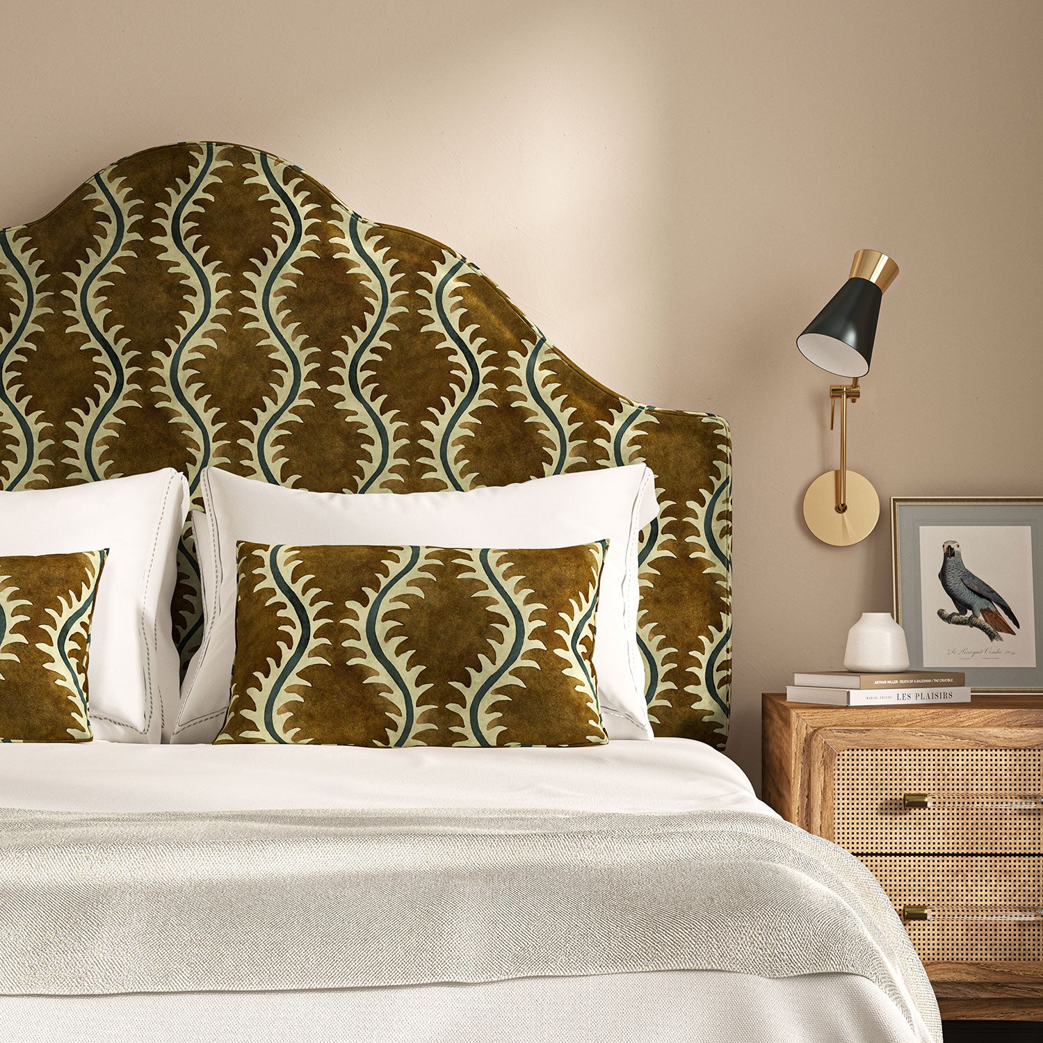 Headboard upholstered in a printed velvet fabric in brown and green featuring a stylized fern pattern.