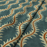 A printed velvet fabric sample in blue and orange featuring a stylized fern pattern.