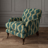 Armchair upholstered in a printed velvet fabric in blue and orange featuring a stylized fern pattern.