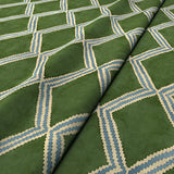 Close-up of green and blue printed velvet fabric featuring an irregular diamond motif with a soft, luxurious pile. 
