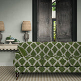 Sofa upholstered in green and blue printed velvet featuring an irregular diamond motif, styled in a timeless living room.
