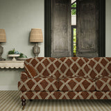Velvet sofa covered in a brown and blue irregular diamond motif fabric