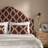 Bedroom with a curved upholstered headboard covered in plum printed velvet featuring an irregular diamond motif.