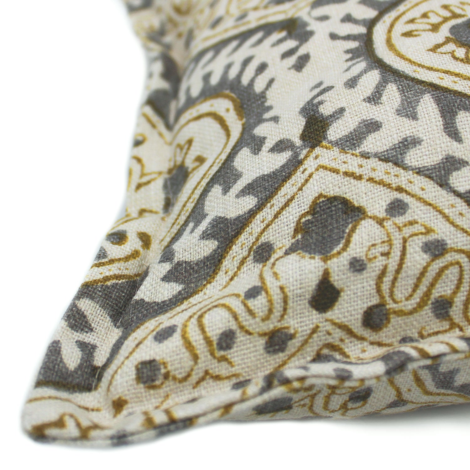 A grey, cream and brown linen cushion with a central motif pattern.