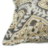 A grey, cream and brown linen cushion with a central motif pattern.