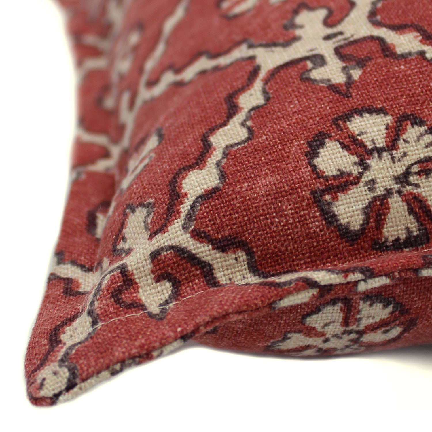 A red and cream linen cushion with a traditional Uzbekistan hand block prints pattern.