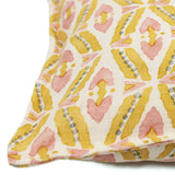 A multicoloured linen cushion with a geometric pattern.