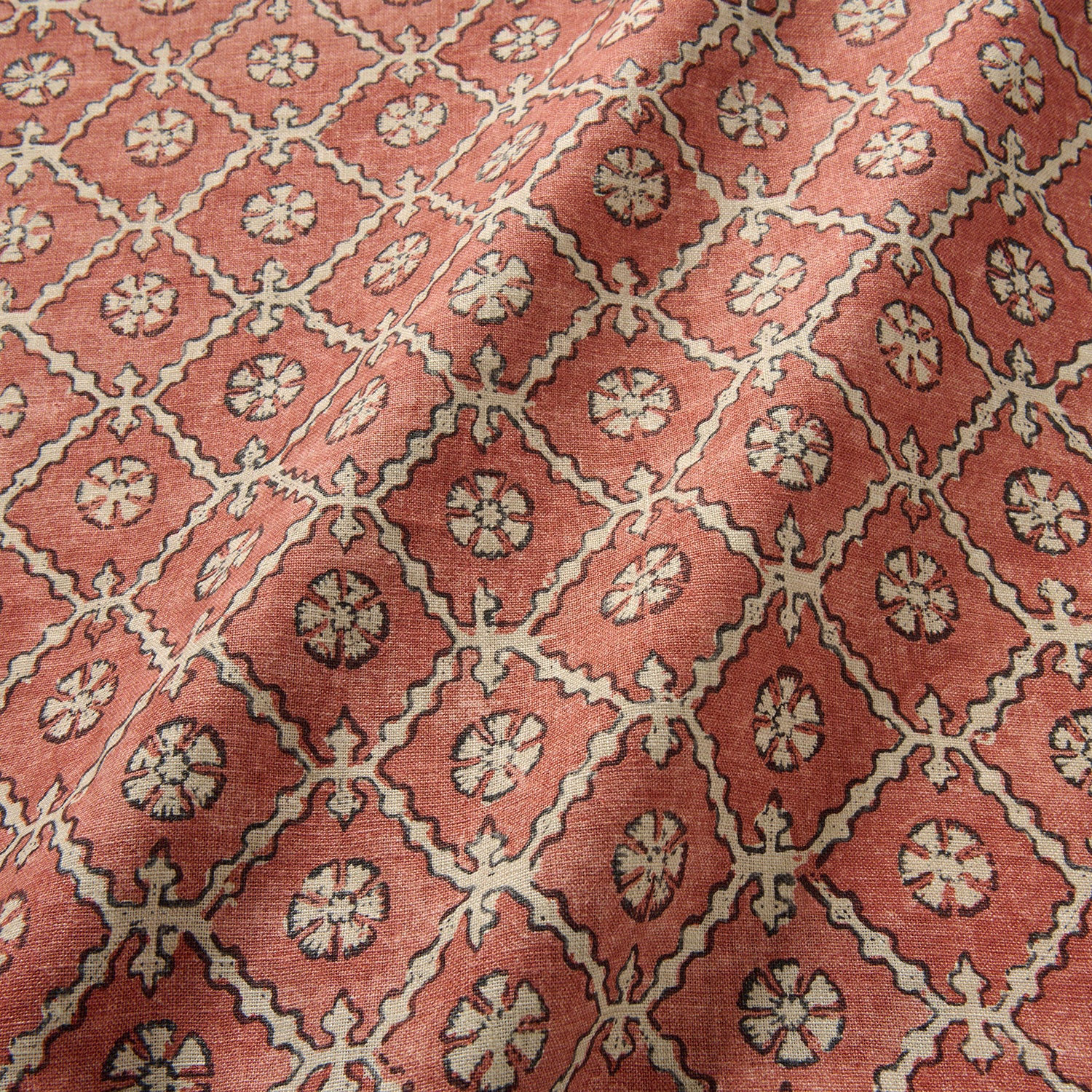 Linen fabric with a hand block-style pattern in red, black and cream