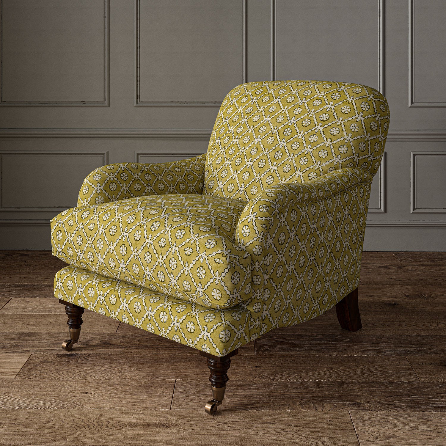 Armchair covered in a linen fabric with a hand block-style pattern in yellow, black and cream