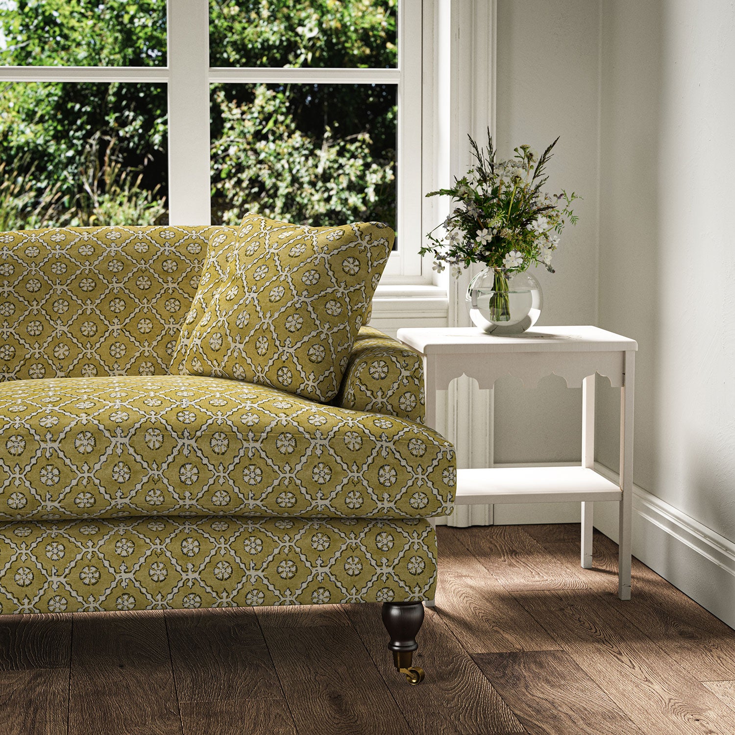 Sofa covered in a linen fabric with a hand block-style pattern in yellow, black and cream