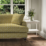 Sofa covered in a linen fabric with a hand block-style pattern in yellow, black and cream