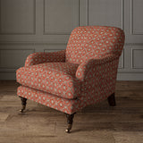 Armchair covered in a linen fabric with a hand block-style pattern in red, black and cream