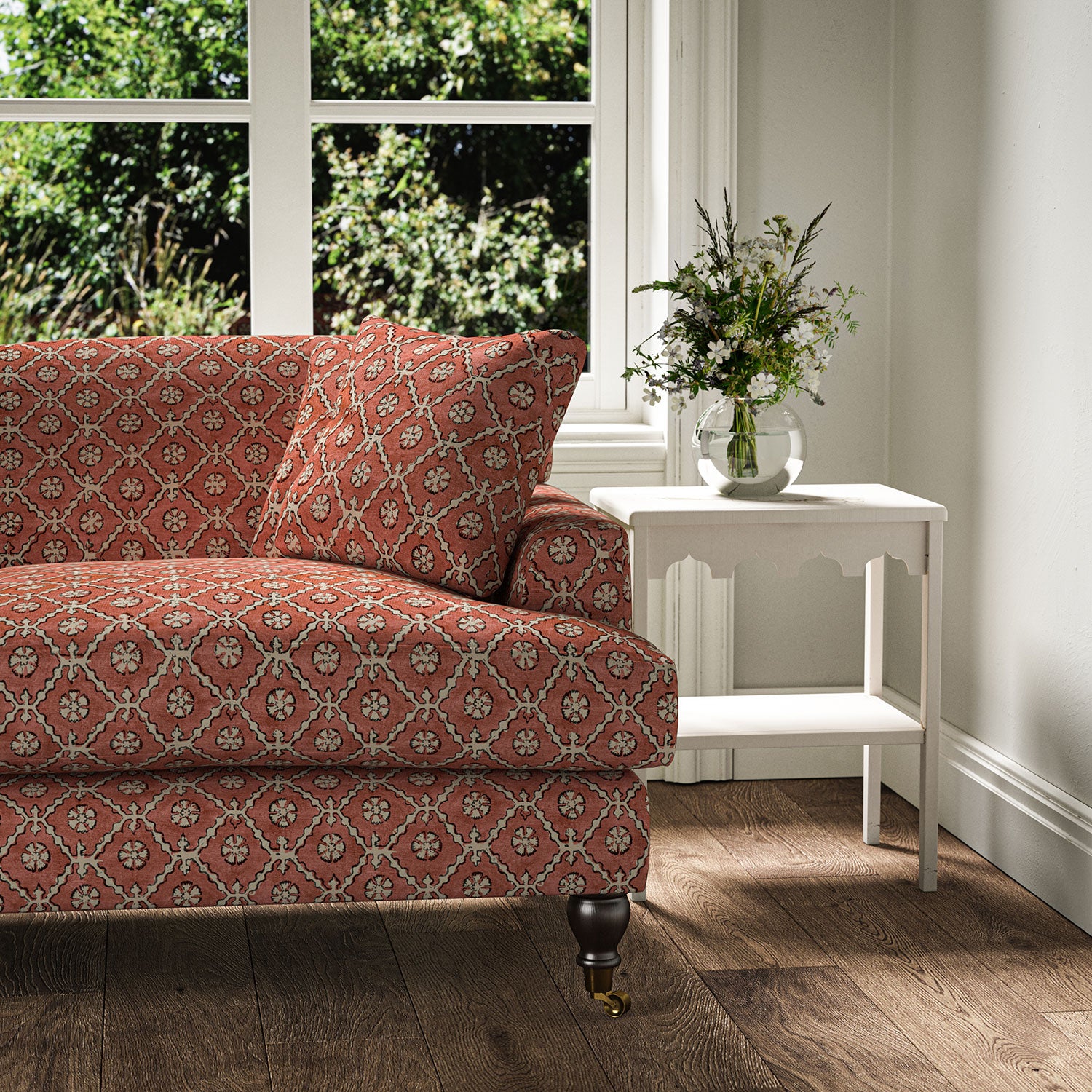 Sofa covered in a linen fabric with a hand block-style pattern in red, black and cream