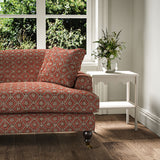 Sofa covered in a linen fabric with a hand block-style pattern in red, black and cream