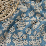 A jolly printed linen fabric in blue, black and cream