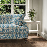 Sofa covered in a jolly printed linen fabric in blue, black and cream