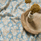 A jolly printed linen fabric in blue, yellow and cream