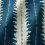 A printed linen fabric sample in blue and off white featuring a striped fern design.