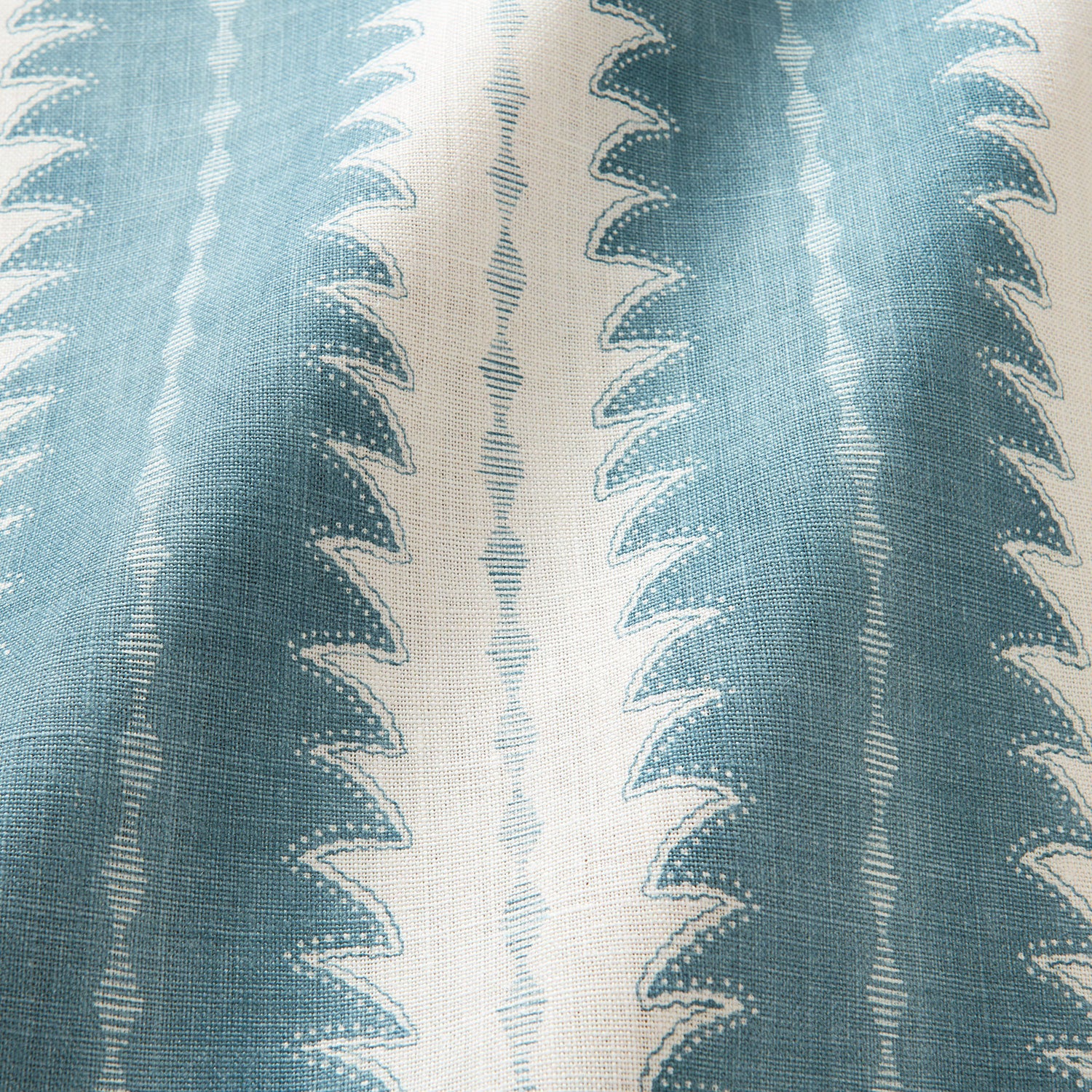 A printed linen fabric sample in blue and off white featuring a striped fern design.