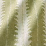 A printed linen fabric sample in green and off white featuring a striped fern design.