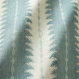 A printed linen fabric sample in blue and off white featuring a striped fern design.