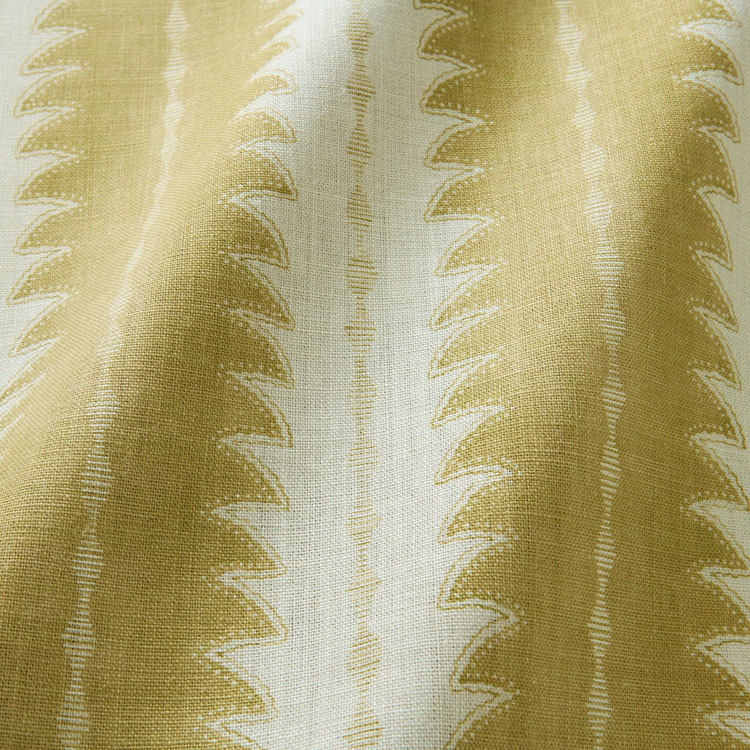 A printed linen fabric sample in yellow and off white featuring a striped fern design.