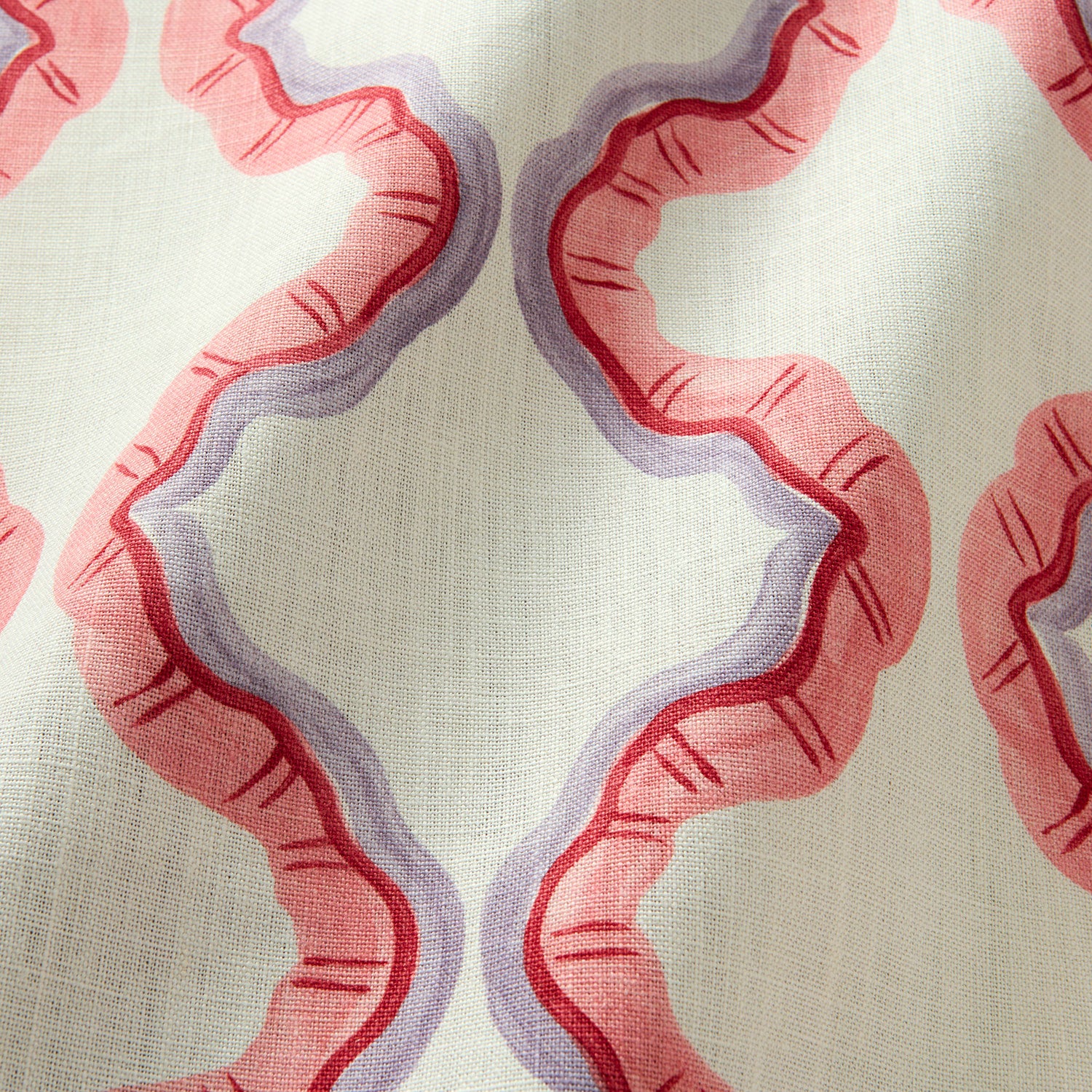 A printed linen fabric sample in pink, purple, red, and off white featuring a mirrored ribbon pattern.