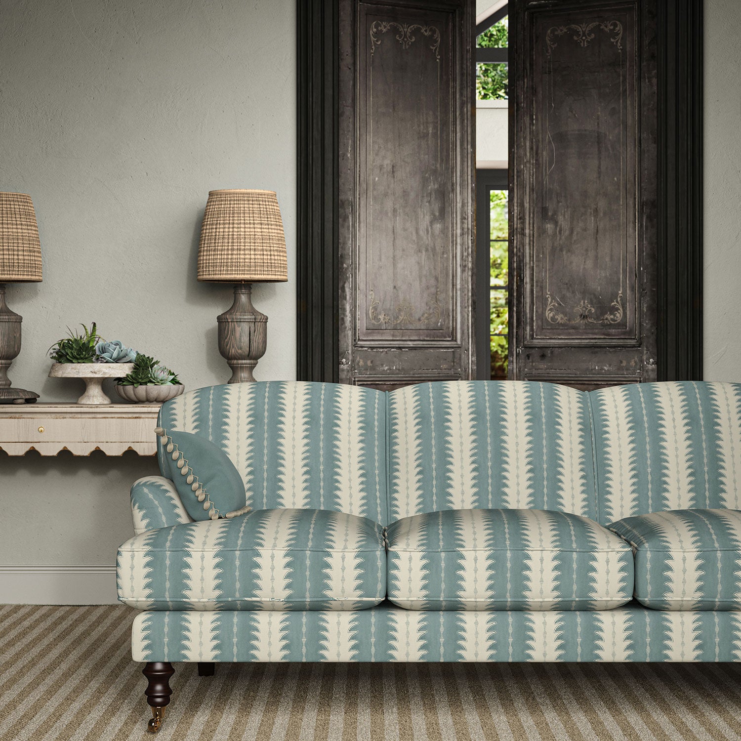 Sofa upholstered in a printed linen fabric in blue and off white, featuring a striped fern design.