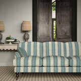 Sofa upholstered in a printed linen fabric in blue and off white, featuring a striped fern design.