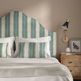 Headboard upholstered in a printed linen fabric in blue and off white, featuring a striped fern design.