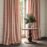 Curtains made from a printed linen fabric in red and off white, featuring a striped fern design.