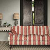 Sofa upholstered in a printed linen fabric in red and off white, featuring a striped fern design.