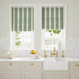Blinds made from a printed linen fabric in blue and off white, featuring a striped fern design.