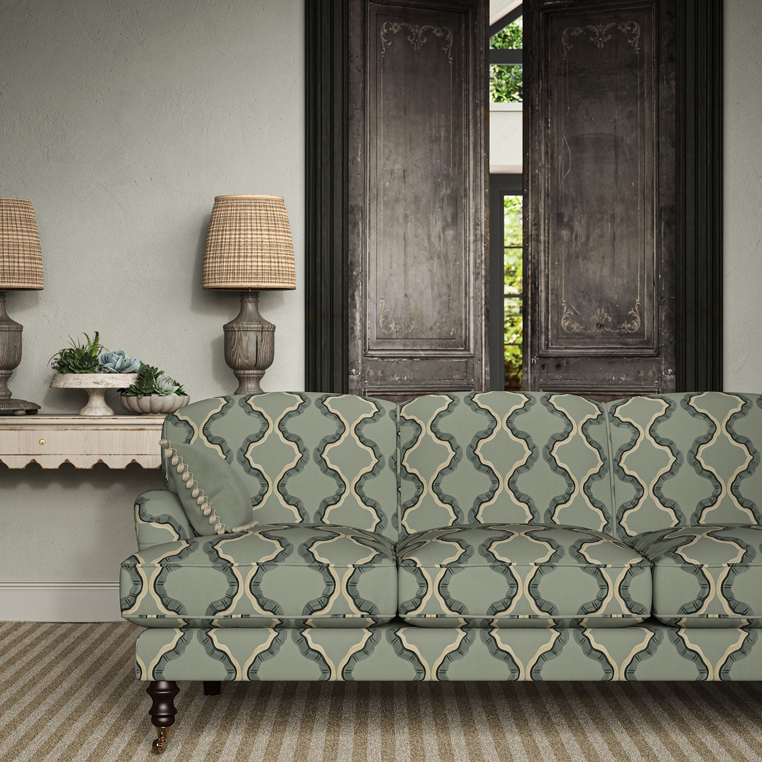 Sofa upholstered in a printed linen fabric in blue, black, and off white featuring a mirrored ribbon pattern.