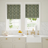 Blinds made from a printed linen fabric in blue, black, and off white featuring a mirrored ribbon pattern.